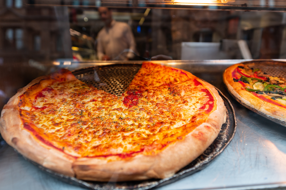 Franquia de pizzas pré-assada: pizza de mussarela exposta em uma pizzaria.